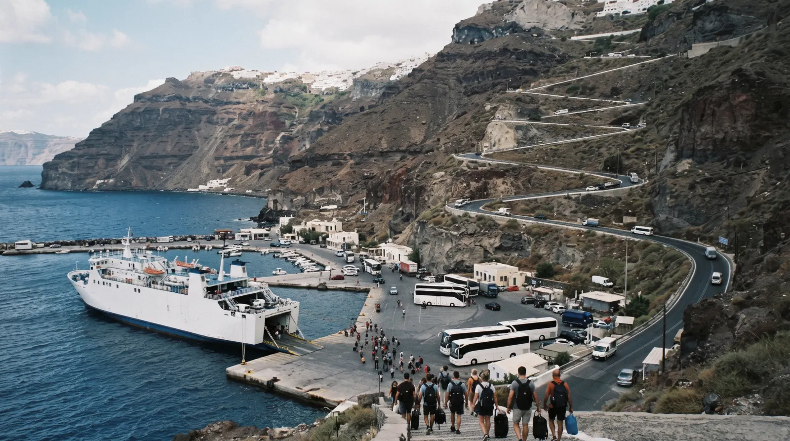 Athinios port at the foot of the caldera cliff with the hairpin road climbing up, athinios port, Santorini Greece